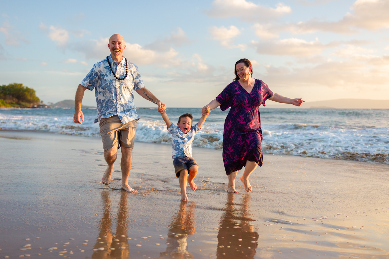 A family running together on a Wailea beach during a Maui Mini Session