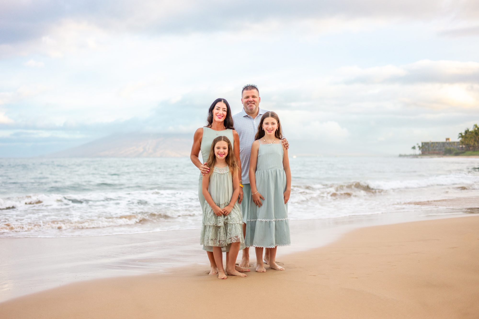 A family photographed in soft sunrise light on Maui