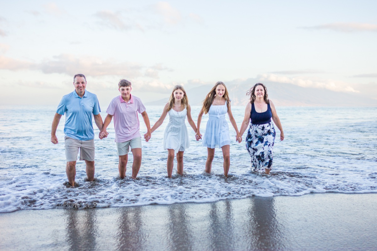 A family of five walking through the water during a recent Maui Mini Session