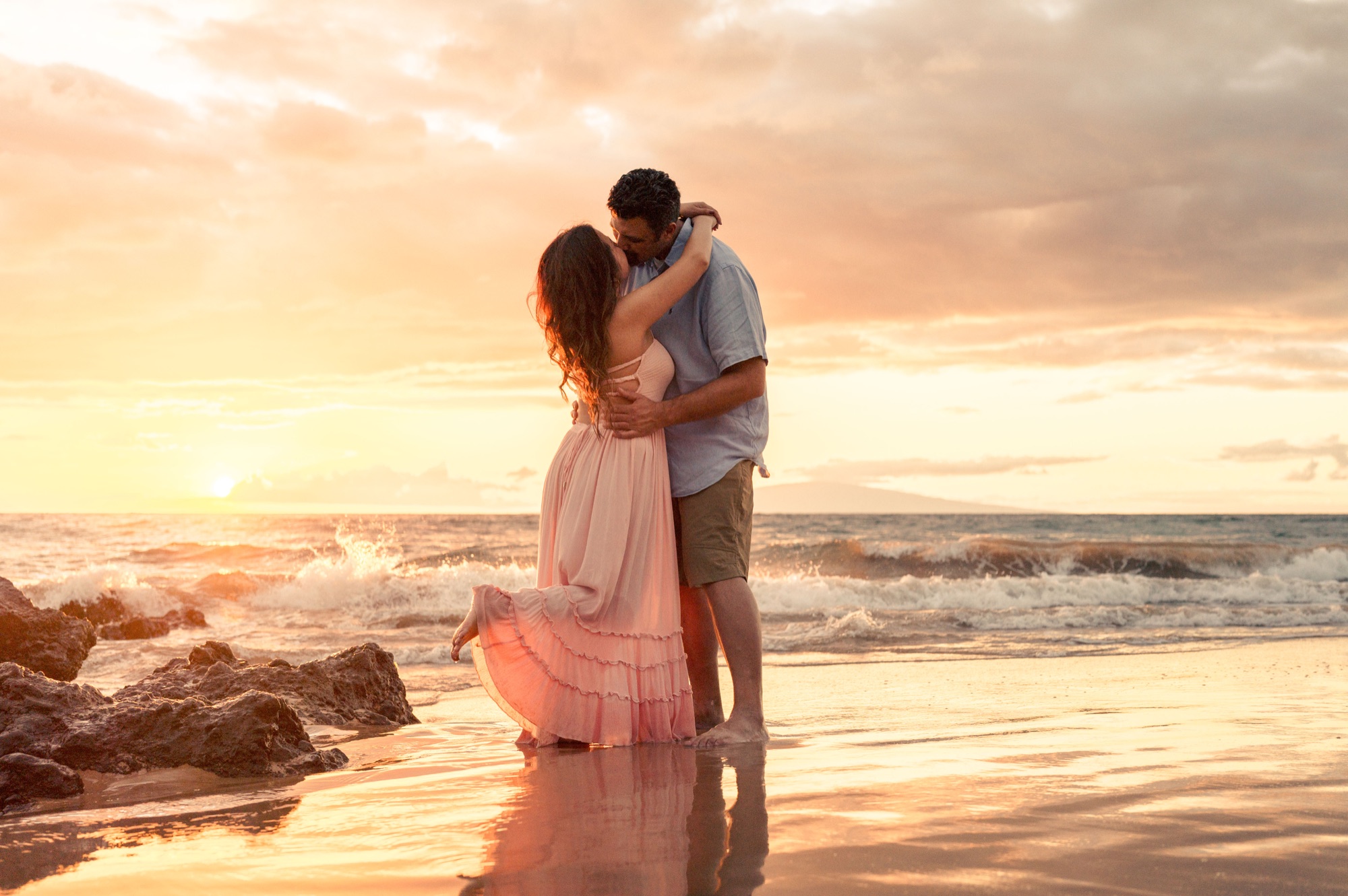 A couple embracing at sunset on a Wailea beach