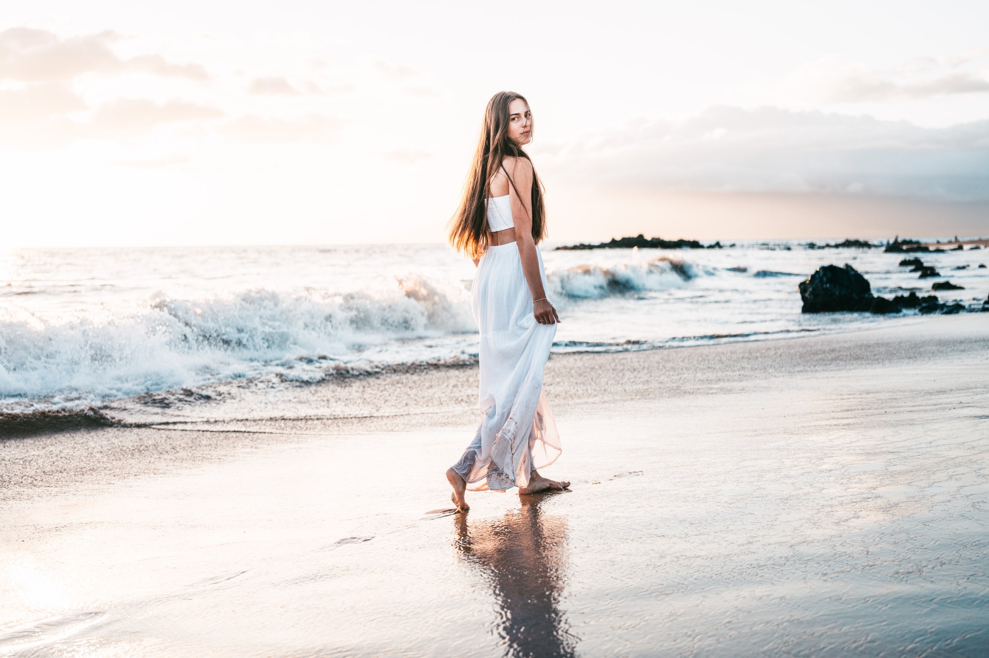A family enjoying the shoreline during golden hour in Maui