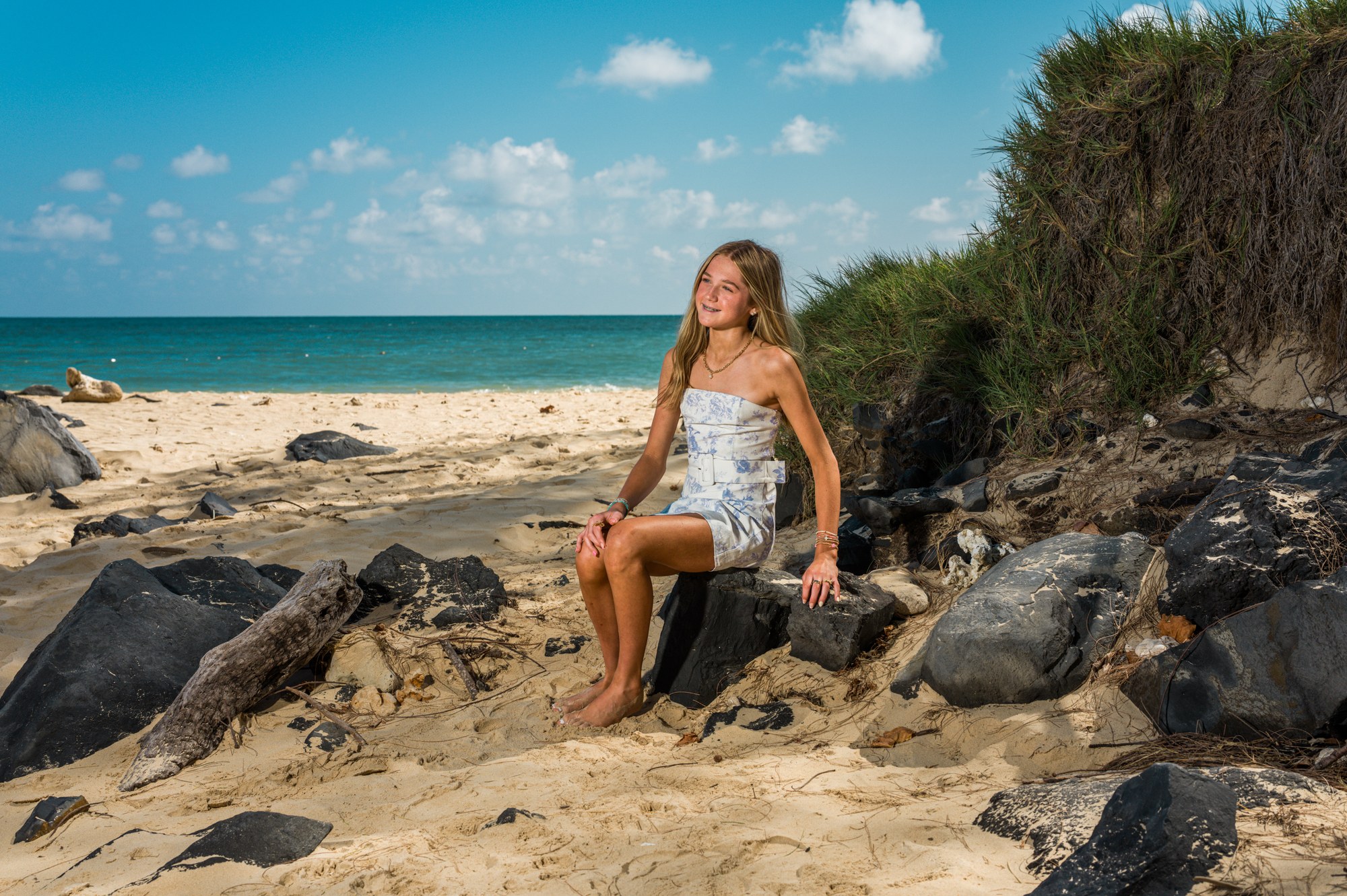 A relaxed vacation portrait beside tropical blue water
